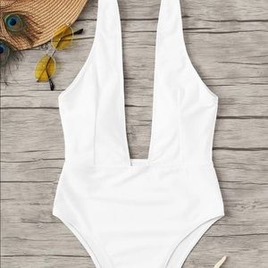 Plunging white one piece swimsuit
